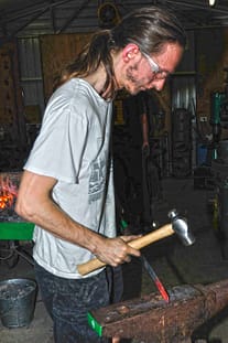 Richard, making arrow points.