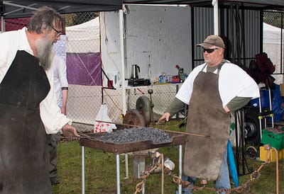 Andrew and Anthony working the forge looking the part.