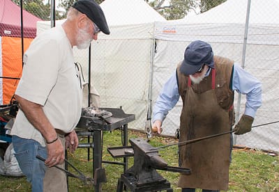 Chris and Peter striking the iron.